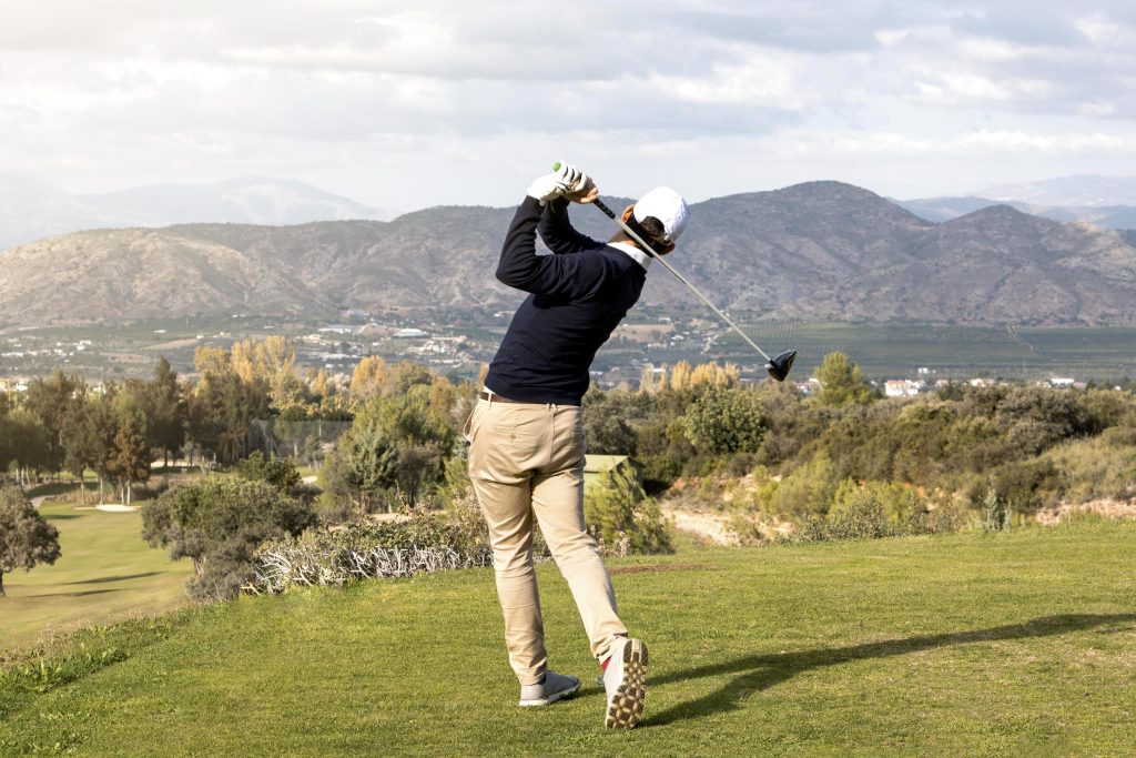 Golf Swing Breakdown: Back view of man playing golf on the golf course