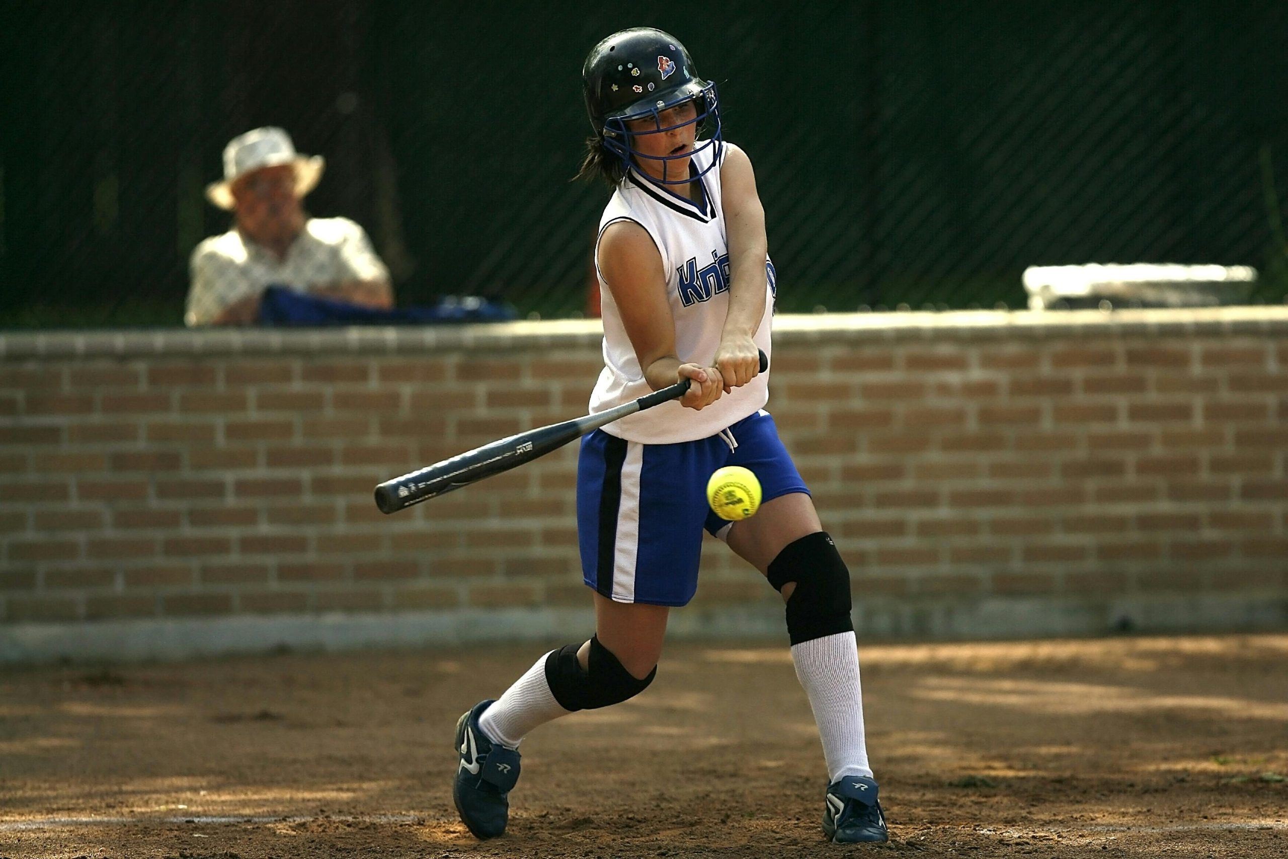 softball player hitting the ball