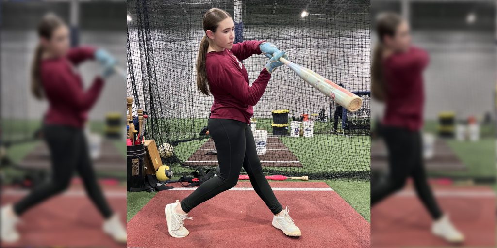 Young softball player practicing her swing