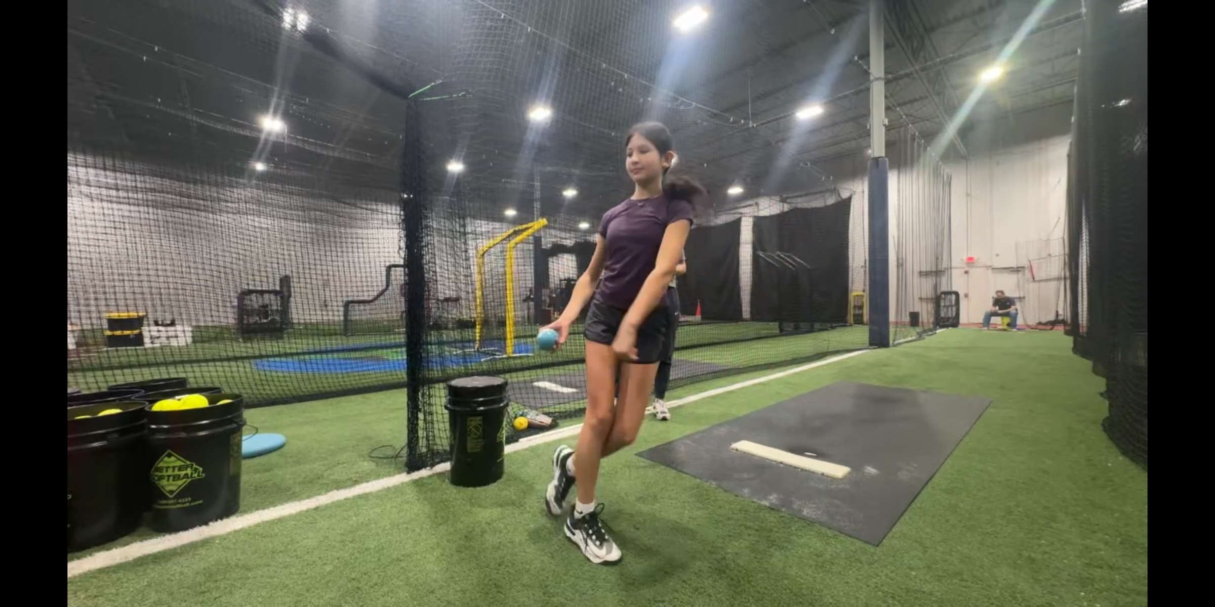 softball pitching session - pitcher girl throwing a ball