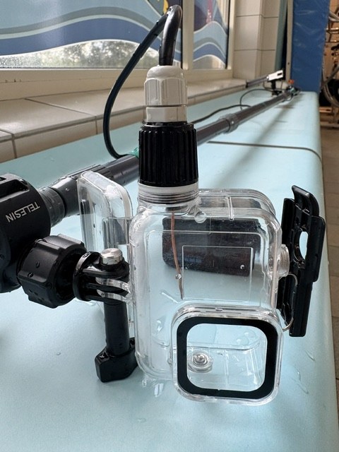 Open underwater housing showing the antenna wire inside and the cable gland on top