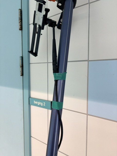 External antenna and cabling taped along the telescopic camera pole, with the iPad holder at the top